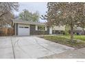 Inviting two-story home with a wide driveway, attached garage, and well-kept lawn at 1352 S Terry St, Longmont, CO 80501