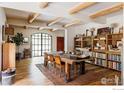 Inviting dining room featuring hardwood floors, exposed beams, and large windows for ample natural light at 15789 N 83Rd St, Longmont, CO 80503