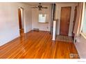 Spacious living area showcases hardwood floors, neutral walls and classic ceiling fan fixture at 1633 S Alcott St, Denver, CO 80219