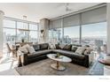 Inviting living room with a large sectional sofa, city views, and modern decor at 1700 Bassett St # 1808, Denver, CO 80202