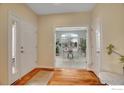 Inviting foyer with hardwood floors and doorway looking to bright office space at 1993 Cedarwood Pl, Erie, CO 80516