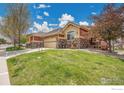 Well-maintained home with beautiful lawn and blue sky on a sunny day in a quiet location at 1993 Cedarwood Pl, Erie, CO 80516