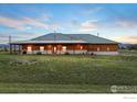 Charming home exterior with a metal roof and expansive green lawn at 2139 S County Road 15, Berthoud, CO 80513