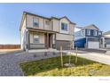 Attractive two-story home featuring a covered porch and a well-maintained lawn at 2231 Crosswind St, Fort Lupton, CO 80621