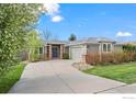 Inviting home exterior featuring lush landscaping, brick accents, and a well-maintained lawn at 2330 Sandpiper Dr, Lafayette, CO 80026