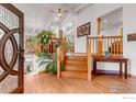 Spacious entryway featuring hardwood floors, a staircase to the upper level, and a decorative front door at 2345 Point Of Pines Dr, Boulder, CO 80302