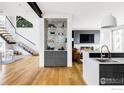 Open concept living space featuring modern staircase and stylish built-in bar and fireplace at 2670 6Th St, Boulder, CO 80304