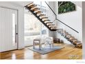 Staircase with glass railings, wood treads, and large windows offering natural light at 2670 6Th St, Boulder, CO 80304