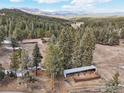 Overhead shot of horse paddock in a lush landscape with mountain views at 27921 Alabraska Ln, Evergreen, CO 80439