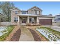 Charming two-story home featuring a covered porch, brick accents, and a well-maintained front yard at 2834 Blue Jay Way, Lafayette, CO 80026