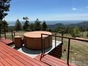Exterior shows a luxurious hot tub on a wooden deck overlooking a beautiful, expansive mountain view at 291 Canon View Rd, Boulder, CO 80302