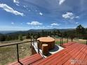 Exterior shows a relaxing hot tub and wooden deck with beautiful mountain views on a sunny day at 291 Canon View Rd, Boulder, CO 80302