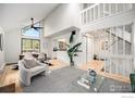 Bright living room with high ceilings, large windows, and a modern staircase, creating an open and airy atmosphere at 3550 Smuggler Cir, Boulder, CO 80305