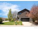 Charming two-story home boasts an attached garage, blossoming tree, and a green lawn at 3809 Howe Ct, Boulder, CO 80301