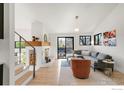 Inviting living room boasts a fireplace, cozy furniture, hardwood floors, and lots of natural light at 3809 Howe Ct, Boulder, CO 80301