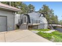 Unique dome-shaped home exterior featuring a modern garage, elevated deck, and easy driveway access at 387 Millionaire E Dr, Boulder, CO 80302
