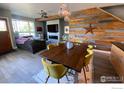 Open-concept living space with wood accent wall, modern fireplace, and large windows at 4661 14Th St, Boulder, CO 80304