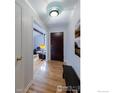 Warm and inviting entryway with hardwood floors, bench seating and interior door on the left at 4760 Harrison Ave, Boulder, CO 80303