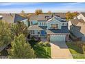 Beautiful two-story home boasting a well-kept lawn and an attached two car garage at 6317 Ruby Hill Dr, Frederick, CO 80516