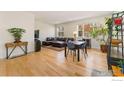 Bright living room featuring hardwood floors, large windows, and comfortable seating at 671 Robert St, Longmont, CO 80503