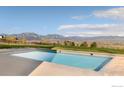 Backyard pool with mountain views and well-manicured lawn at 7509 Panorama Dr, Boulder, CO 80303