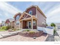 Well-maintained home with stone accents, a covered porch, and a neatly landscaped front yard at 800 Gateway Park Ln, Berthoud, CO 80513