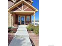 Inviting front porch with decorative columns and chairs, perfect for enjoying a morning coffee at 800 Gateway Park Ln, Berthoud, CO 80513
