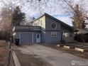 Charming home with a two-car garage and a unique, eye-catching, round window on the second floor at 843 Sumner St, Longmont, CO 80501