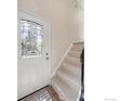 Entryway featuring a decorative glass door, a staircase, and a patterned rug at 10683 Newcombe Way, Broomfield, CO 80021