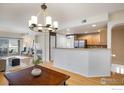 Open-concept living area offering seamless transition into a modern kitchen with a breakfast bar at 1122 Olympia Ave # 12H, Longmont, CO 80504