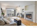 Bright living room with hardwood floors and fireplace at 1122 Olympia Ave # 12H, Longmont, CO 80504