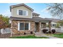 Attractive two-story home with stone accents, a welcoming front porch, and neat landscaping at 11738 Zenobia Loop, Westminster, CO 80031