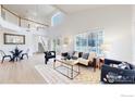 Bright living room with soaring ceilings, large windows, and modern furnishings at 11738 Zenobia Loop, Westminster, CO 80031