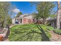 Lush backyard featuring a spacious lawn, mature trees, and a patio area for outdoor enjoyment at 12342 Milwaukee Ct, Thornton, CO 80241