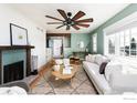 Comfortable living room featuring hardwood floors, stylish rug, and a cozy fireplace at 14117 W 58Th Pl, Arvada, CO 80004