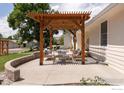 Comfortable outdoor patio featuring a pergola with cozy seating and a fire table at 14117 W 58Th Pl, Arvada, CO 80004