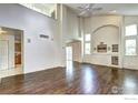 Spacious living room with high ceilings, hardwood floors, built-ins, and backyard access at 1438 Stockton Dr, Erie, CO 80516