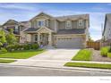 Charming two-story home with a well-manicured lawn, covered porch, and attached two-car garage at 17052 Lipan St, Broomfield, CO 80023