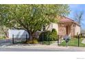 Lovely single-story home with a red tile roof, stone accents, and well-maintained landscaping at 1930 N Shore Dr, Longmont, CO 80503