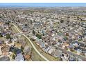 Extensive aerial view of a suburban community with winding roads and many two-story single Gathering homes at 21112 E 45Th Ave, Denver, CO 80249