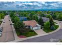 An aerial view of a charming home featuring a brick facade and a three-car garage at 2344 Flagstaff Dr, Longmont, CO 80504
