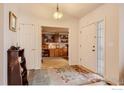 Bright foyer with patterned rug, tiled floors, and an office view at 2344 Flagstaff Dr, Longmont, CO 80504