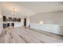 Open concept living room and kitchen features light, airy feel with hardwood floors at 2435 Calais Dr # B, Longmont, CO 80504