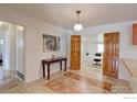 Bright dining area with tile flooring, decorative table, and stylish wood-framed entryway to office at 2561 S Carey Way, Denver, CO 80222