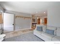Inviting living room with tile floors, neutral walls, coat rack, and a comfortable sofa at 2561 S Carey Way, Denver, CO 80222