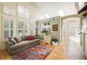 Bright living room showcasing natural light through large windows, hardwood floors, and comfortable seating at 2758 Meadow Mountain Trl, Lafayette, CO 80026