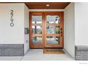 Modern glass-panel front door with sidelights and contemporary hardware creates an inviting entry at 2790 Stanford Ave, Boulder, CO 80305