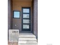 Modern front door with glass panels and brick surround, enhancing curb appeal at 2907 32Nd St, Boulder, CO 80301