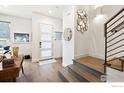 Inviting foyer with wood floors, staircase, modern light fixtures, and stylish decorative accents at 2907 32Nd St, Boulder, CO 80301