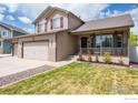 Attractive home with a covered porch, showcasing a well-manicured lawn and a three-car garage at 3761 Anvil Ct, Mead, CO 80542